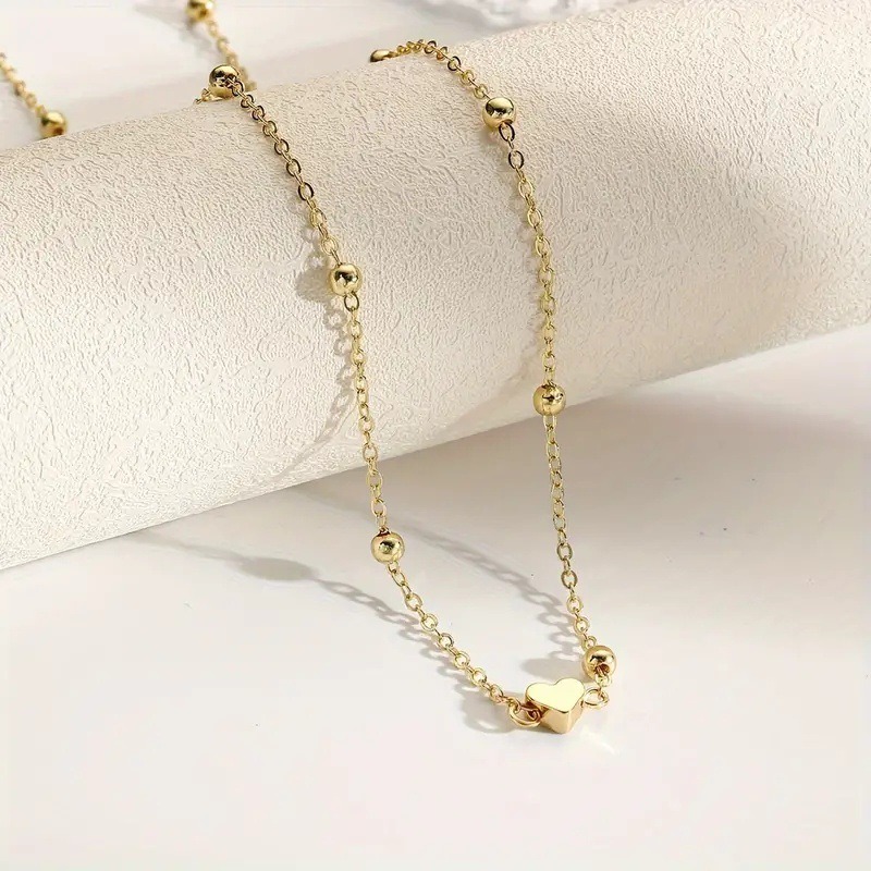 Sierlijke gouden hartvormige t - Body Jewelry For You recensie en prijs